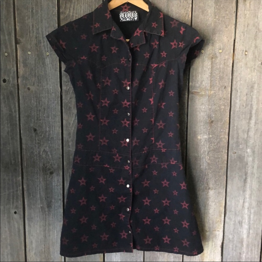 Short fitted snap front black dress w/red stars